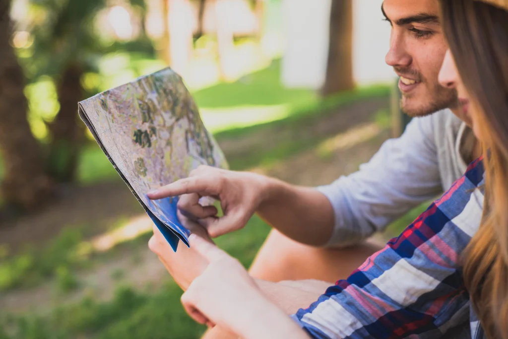 Couple looking at a map of a Neighborhood, doing Research on where to buy their home