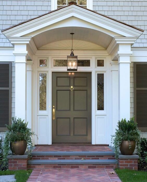 Low-cost tricks to help you sell .A freshly painted front door with updated hardware and neat landscaping, including vibrant flowers.